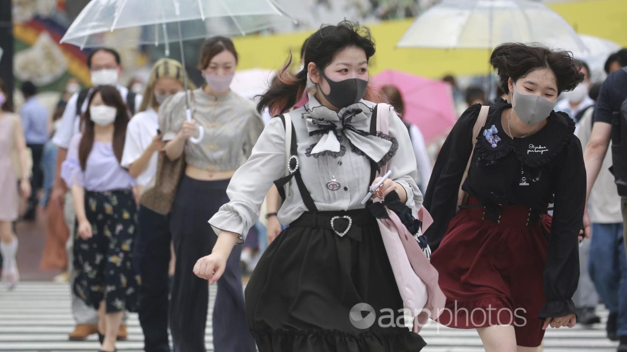 People wearing face masks in Japan in 2021 during the COVID outbreak.