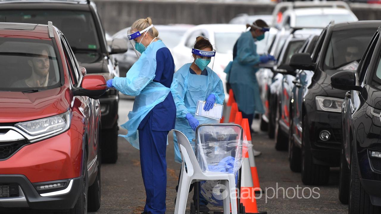 Healthcare workers at a drive-through COVID-19 testing station