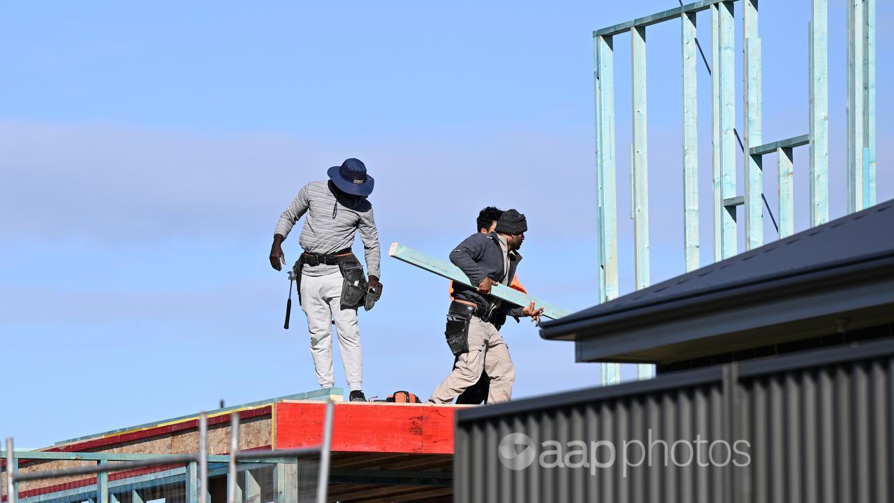 Men on a roof involved in housing construction in Sydney