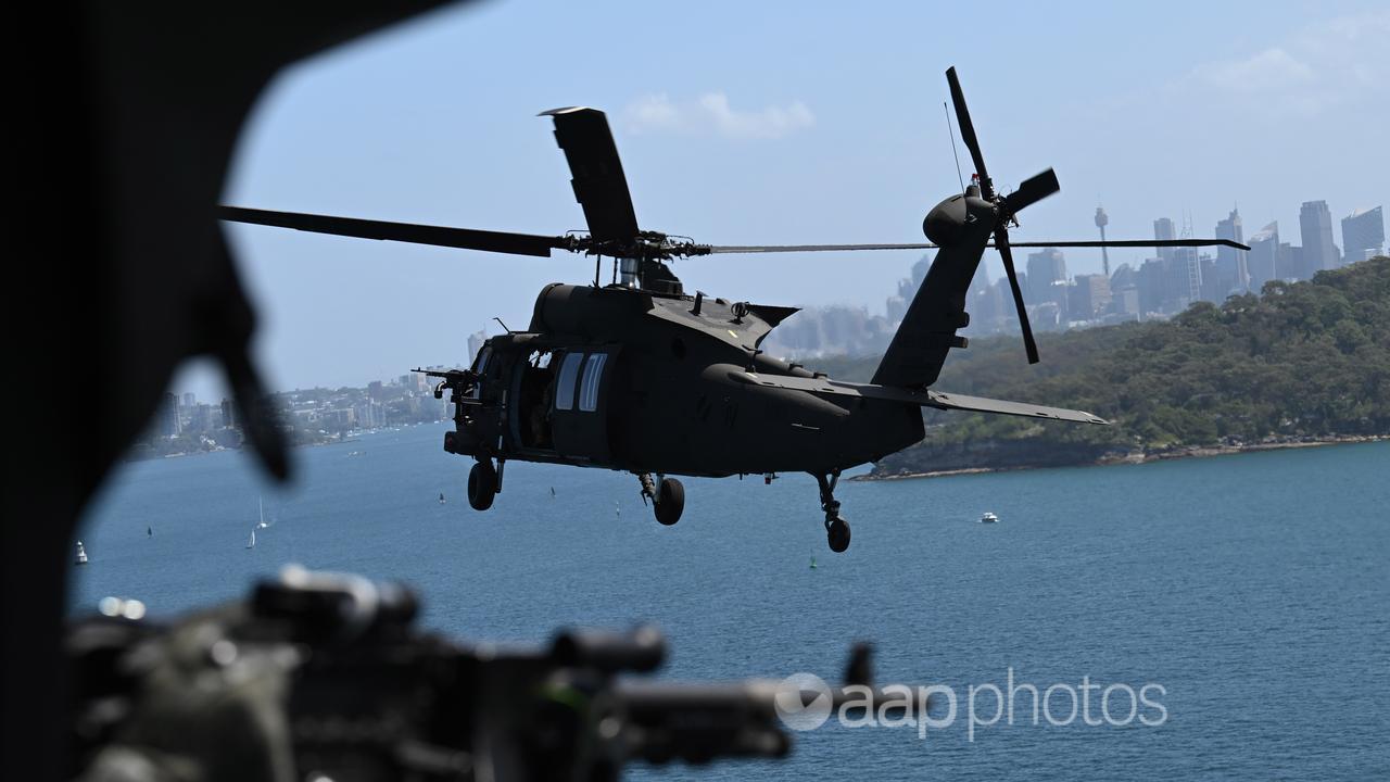 ADF Black Hawk helicopter flies over Sydney Harbour