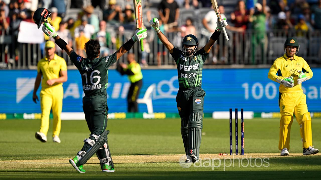 Mohammad Rizwan (left) and Babar Azam celebrate Pakistan's win.