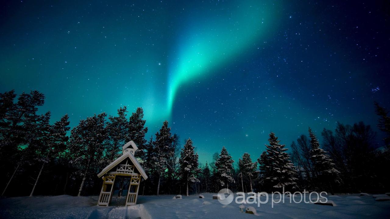 The aurora borealis appears in the sky in northern Norway.