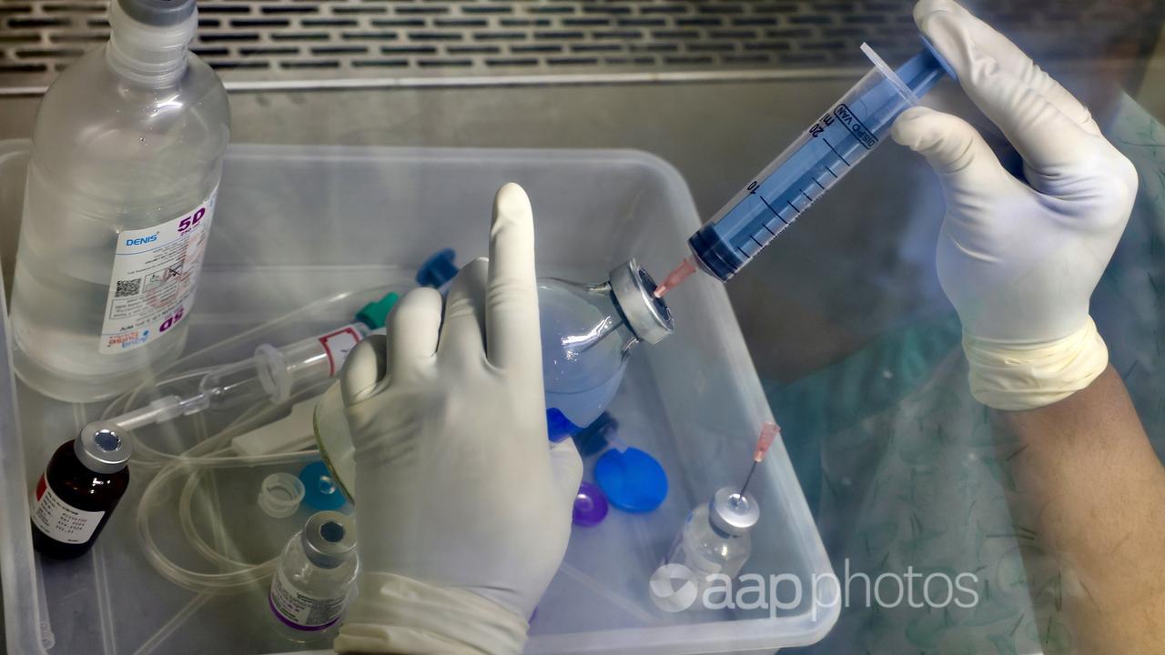 A doctor handling cancer treatment medicines.