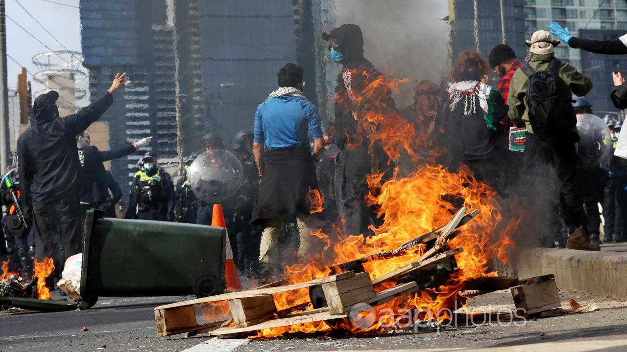 A wooden pallette is set on fire during a protest 