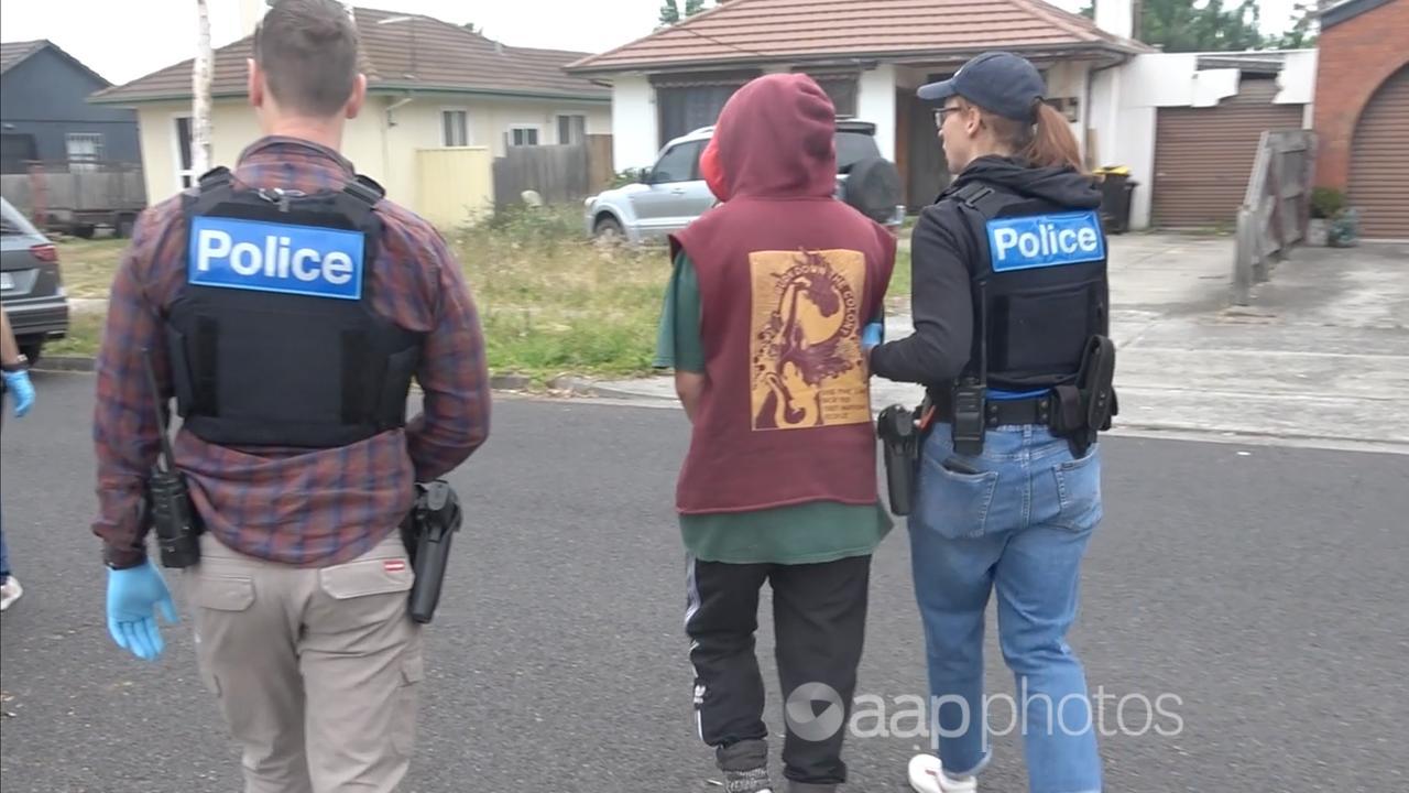 Victoria police officers arrest a protester