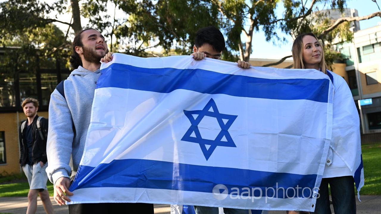 People holding an Israeli flag