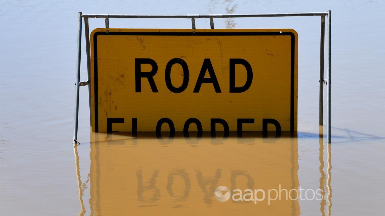 Road flooded sign partially submerged