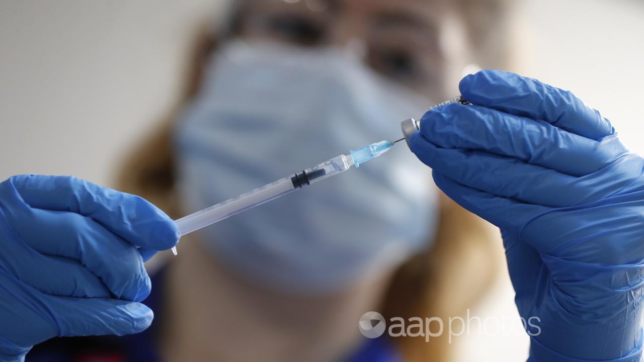 A nnurse prepares a COVID-19 vaccination.