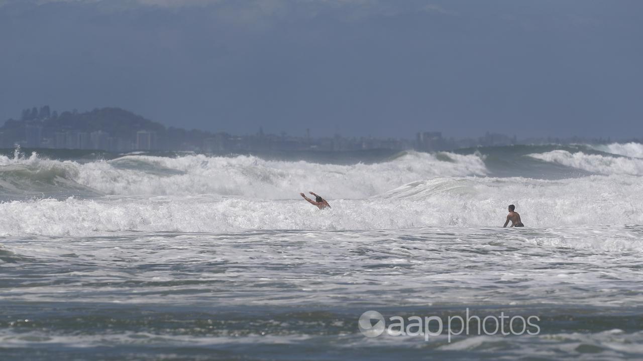 Swimmers in rough surf