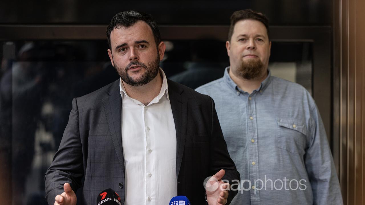 ACTU Acting Secretary Joseph Mitchell and bank employee Adrian Thoen.