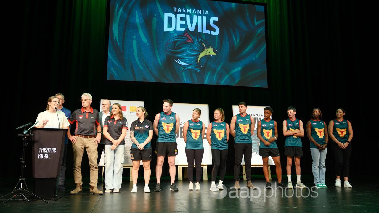 The Tasmanian Devil's guernsey is revealed.