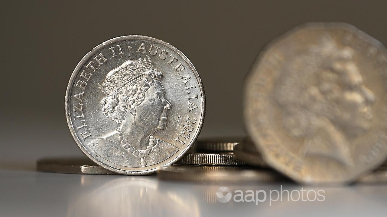 Queen Elizabeth II is seen on a 20 cent coin, next to a 50 cent coin