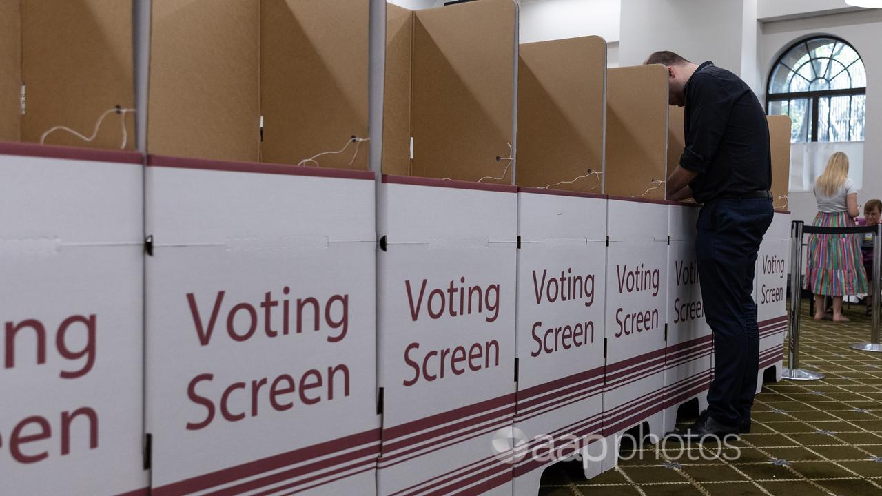 People vote inside Brisbane City Hall ahead of Queensland election