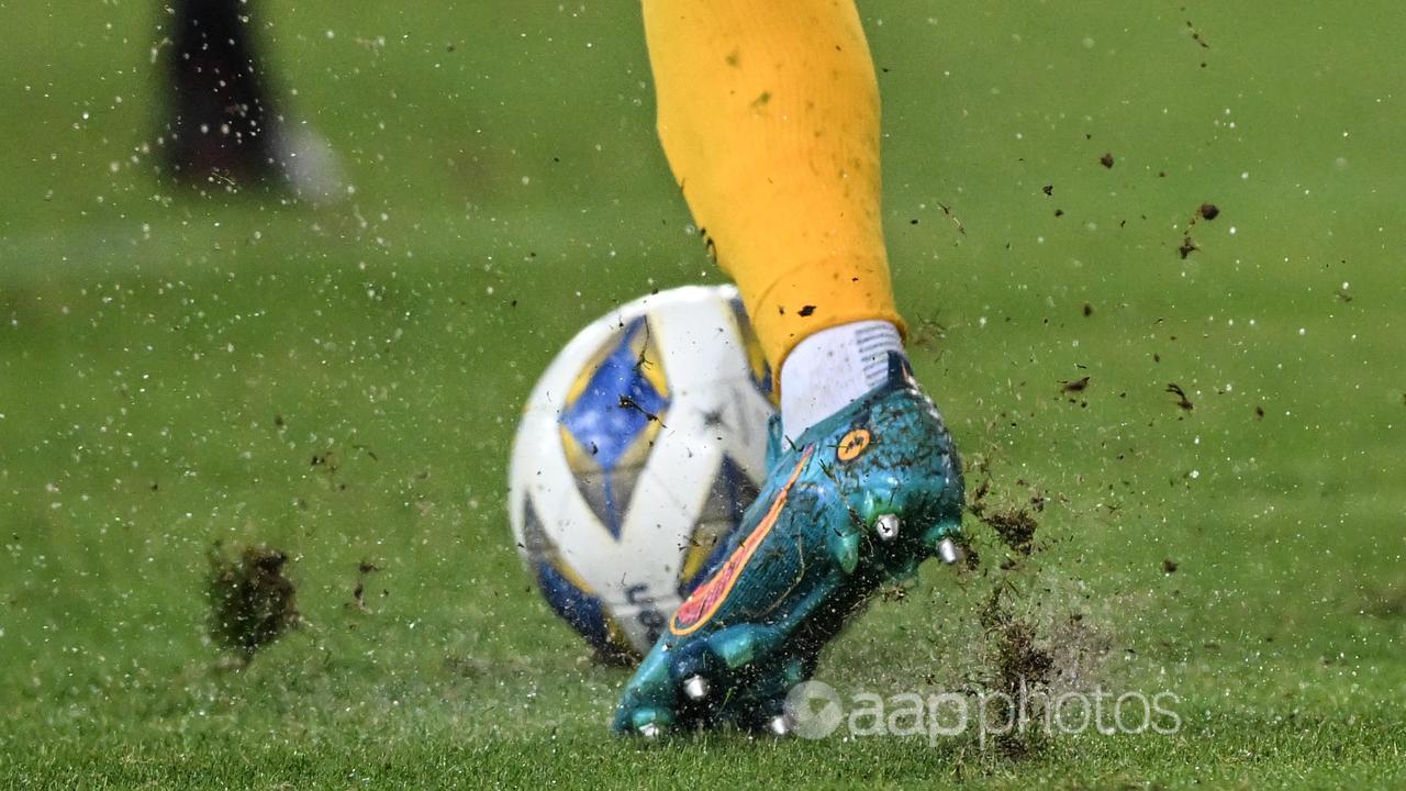 A leg is seen dribbling a soccerball