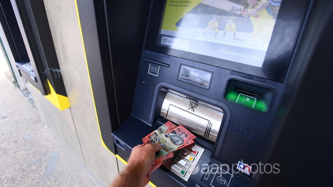 Cash is withdrawn from a Commonwealth Bank ATM.