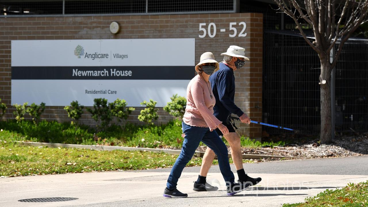 Pair walk past the entrance to Anglicare’s Newmarch House