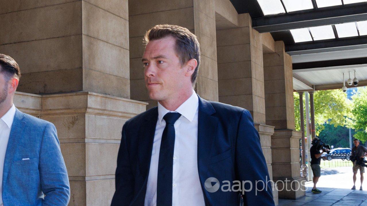 Rohan Dennis (right) leaves the Sir Samuel Way Building in Adelaide