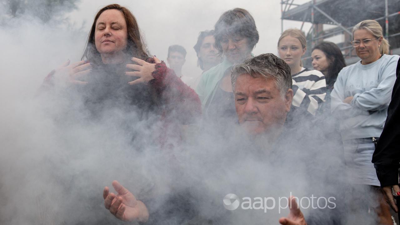 People gather for a smoking ceremony at Alfred Square in Melbourne.